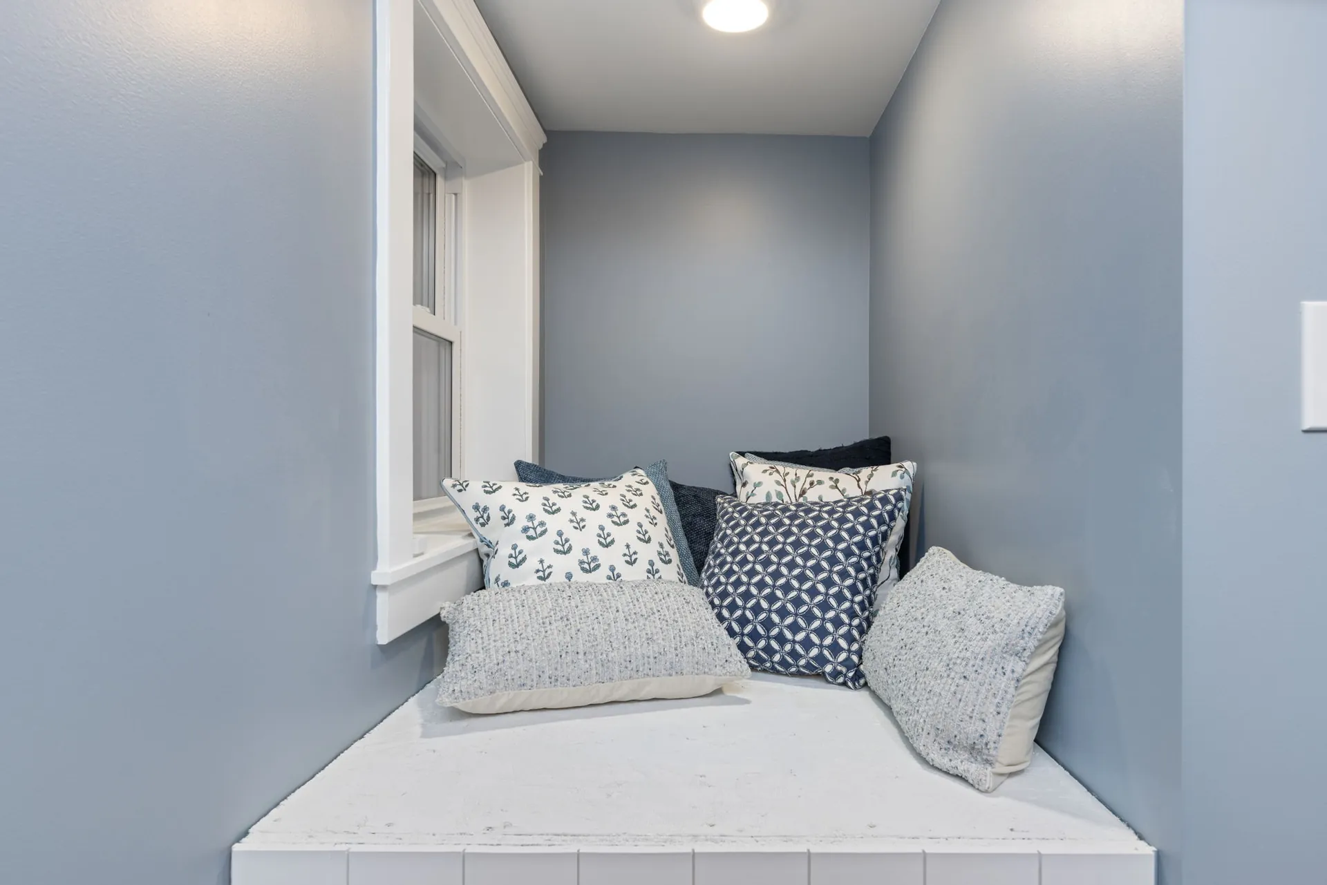 Basement window seat reading nook with cushions and pillows