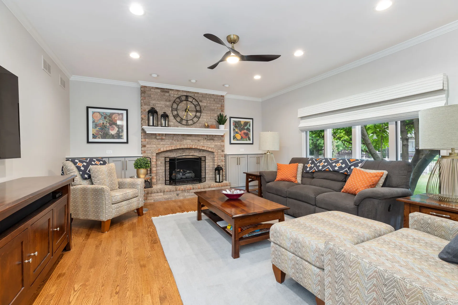 Family room with brick fireplace and picture window from a Naperville remodel