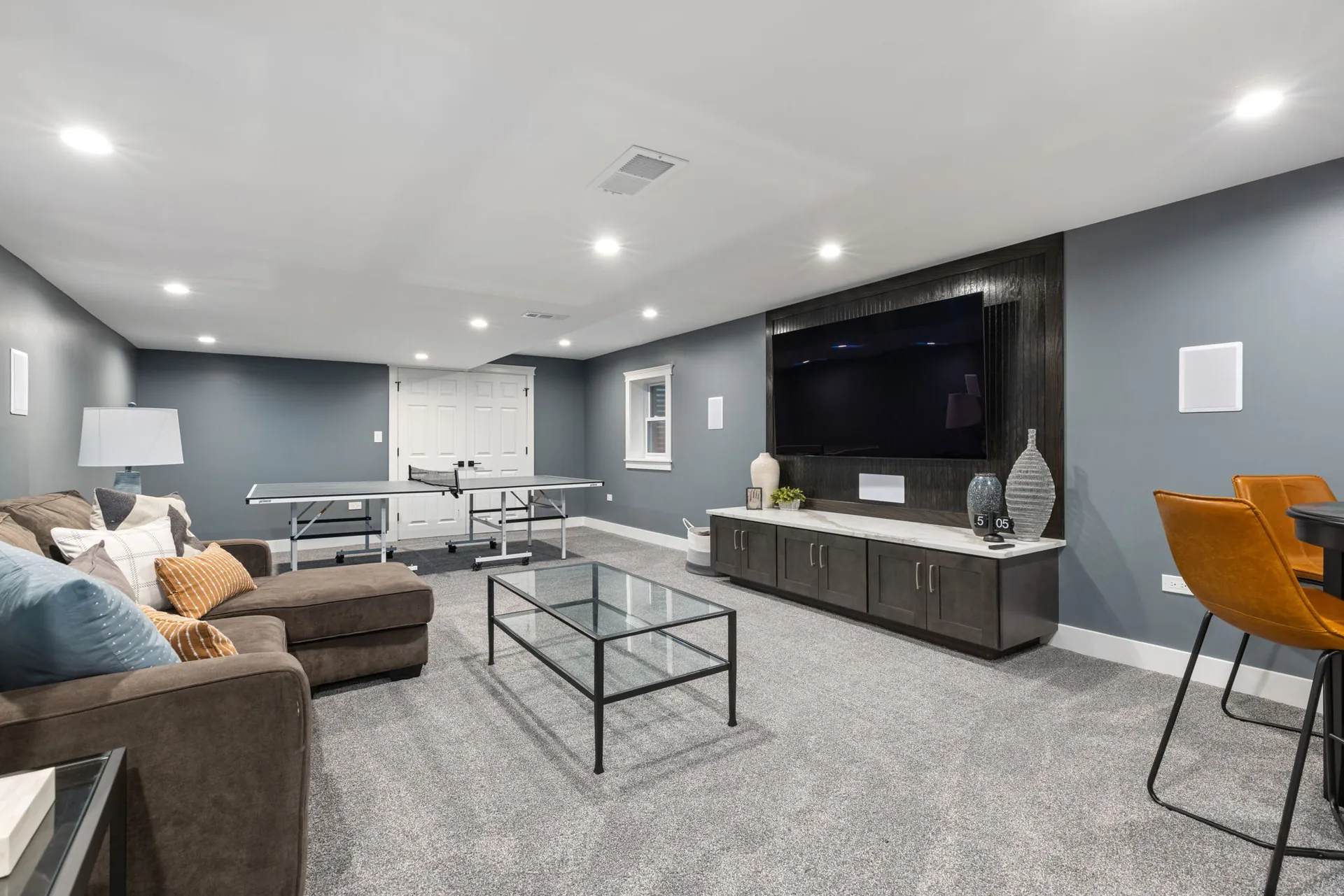 Finished basement rec room with media wall and game area