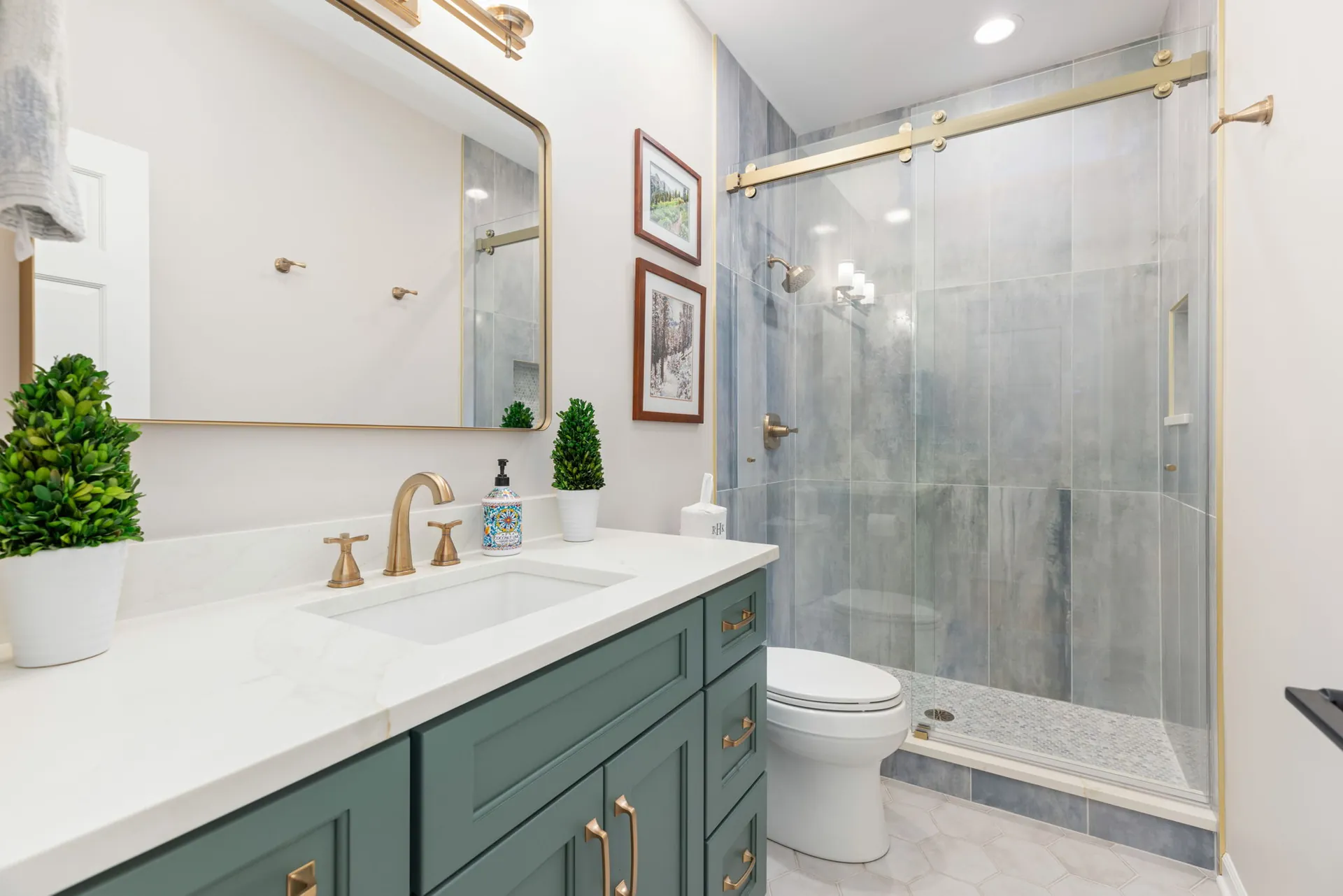 Hall bathroom with green vanity and gray marble-look tile shower